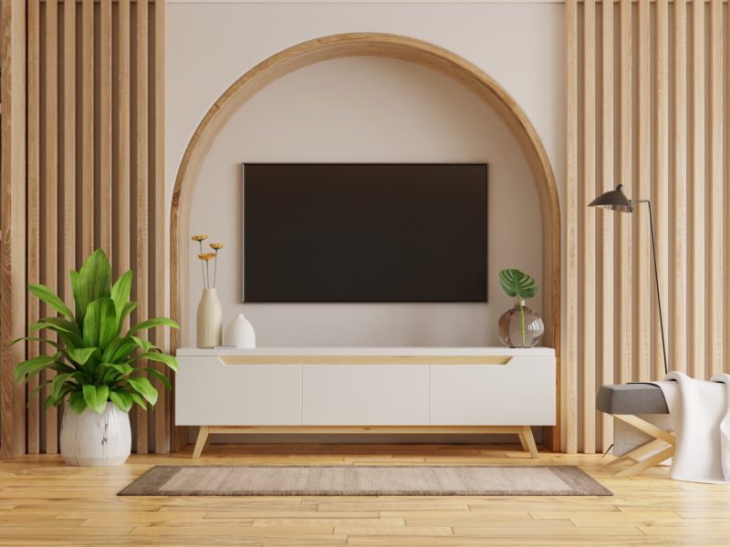 Living room interior with tv on cabinet and decorative lath on empty white wall background.3D rendering